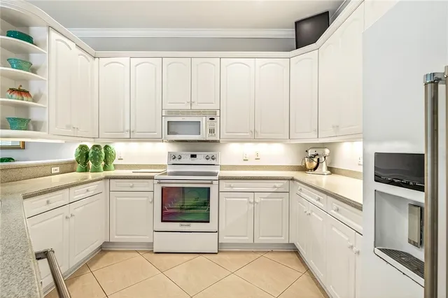 a living room with kitchen island furniture and a chandelier