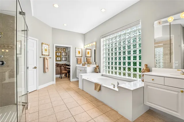 a view of a house with potted plants and a table and chairs