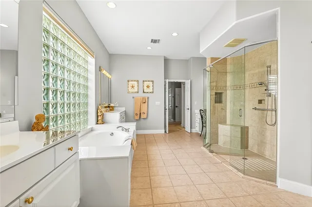 a large white room with a large window and stainless steel appliances