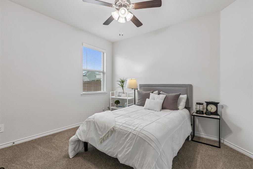 10313 Geode Street Aubrey, TX 76227 - Photo 7 of 13 Carpeted room featuring a single window with blinds, a ceiling fan with light fixture, and neutral painted walls