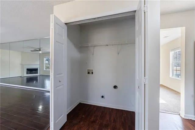 a view of a hallway with wooden floor and closet