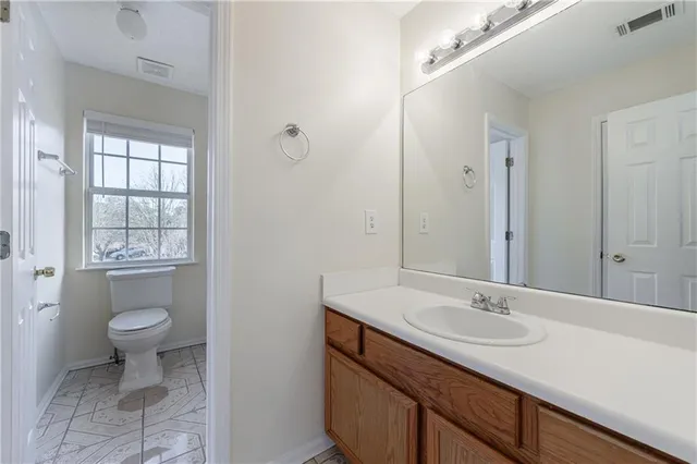 a white toilet sitting next to a bath tub