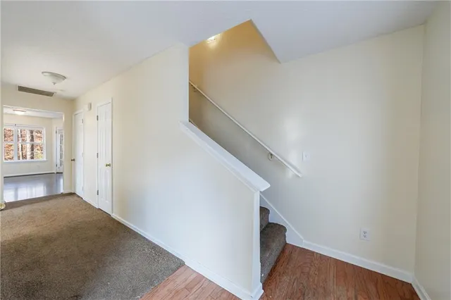 a view of entryway and hall with wooden floor