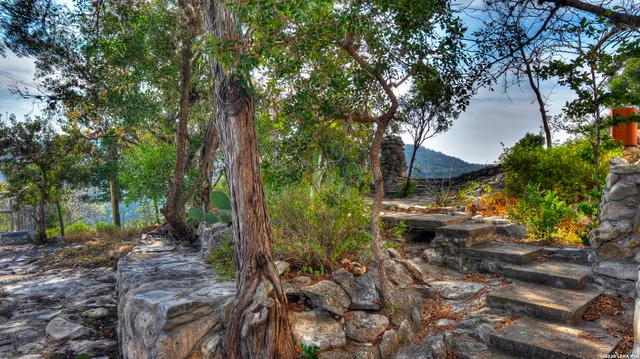a living room with dining table furniture a chandelier and a large window
