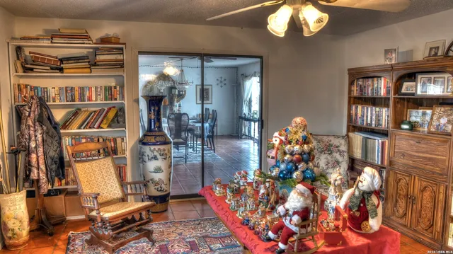 a kitchen with stainless steel appliances granite countertop a refrigerator a sink a stove and a dining table with wooden floor