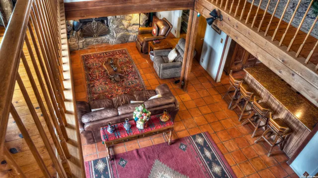 a room with lots of furniture and a book shelf