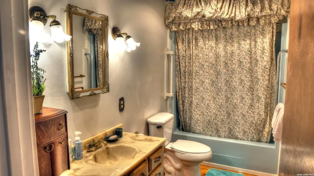 a kitchen with granite countertop a sink a stove and wooden cabinets