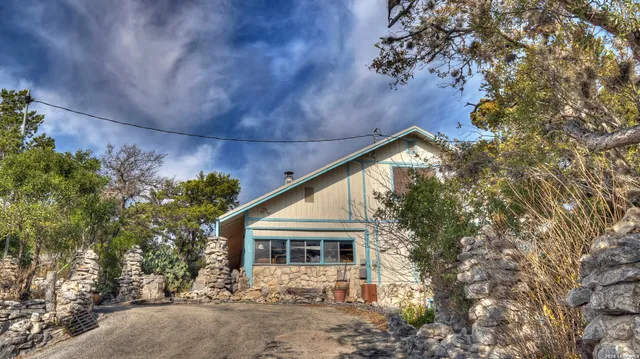 a view of a back yard of the house and a fountain