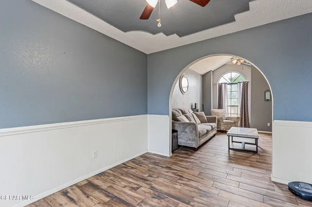 a living room with furniture and a chandelier
