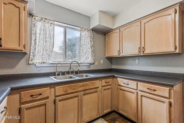 a kitchen with stainless steel appliances granite countertop a sink a stove and cabinets