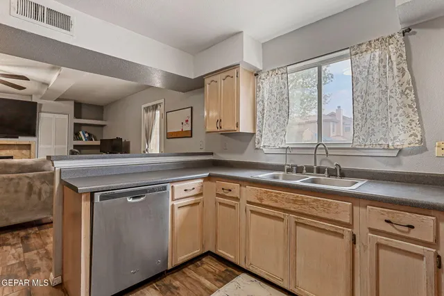 a kitchen with a sink stove and cabinets