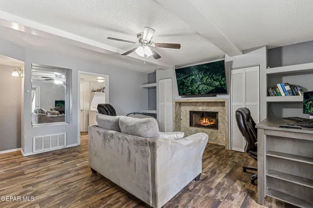a living room with furniture and a fireplace