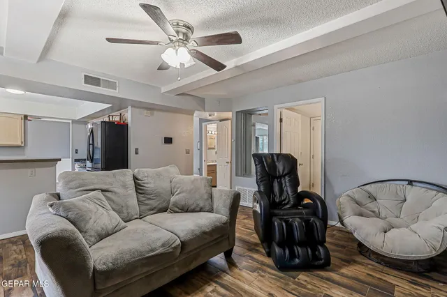 a living room with furniture and a chandelier