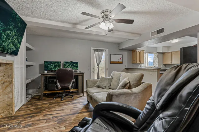 a living room with furniture a chandelier and a flat screen tv