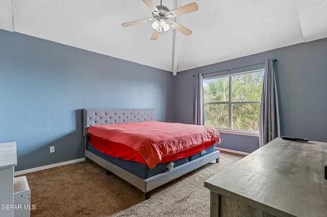 a bed sitting in a bedroom next to a window