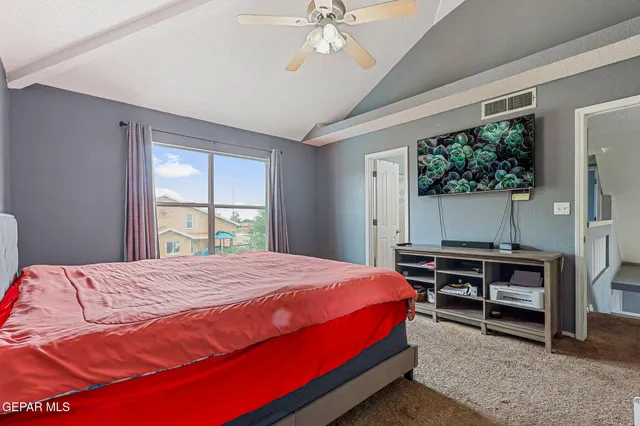 a bedroom with a bed table and window