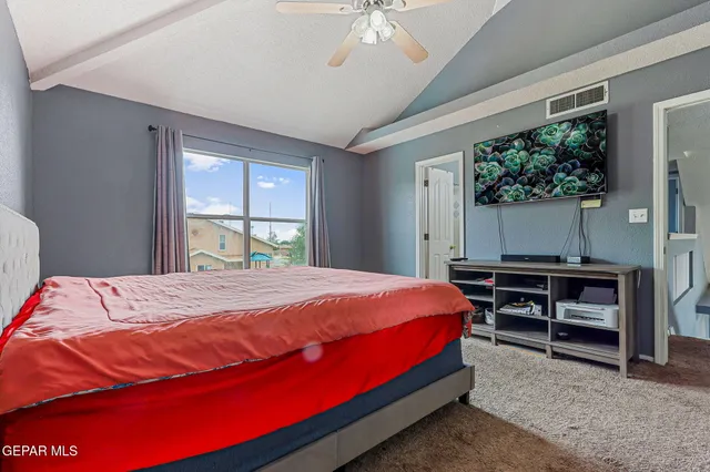 a bed sitting in a bedroom next to a window