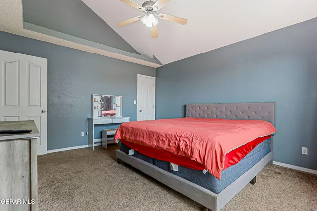 a bed sitting in a bedroom next to a chandelier