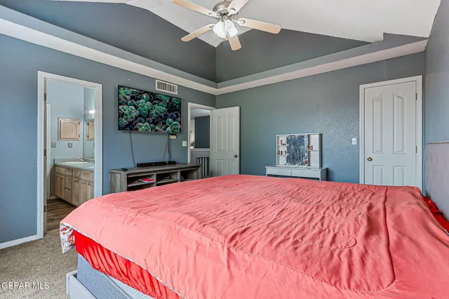 a bed room with a bed and a television