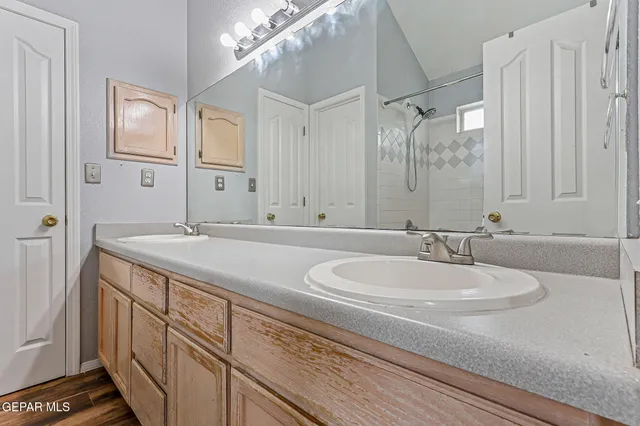 a bathroom with a double vanity sink and a mirror
