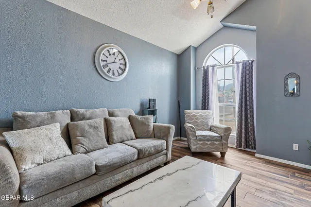 a living room with furniture and a large window