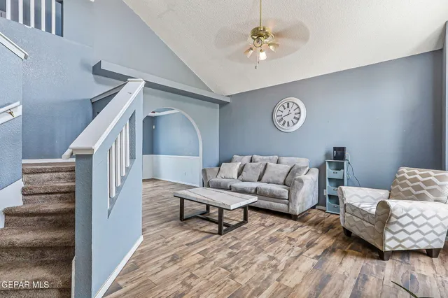 a living room with furniture and wooden floor