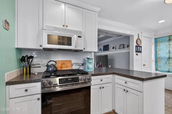 a kitchen with cabinets stainless steel appliances and a sink