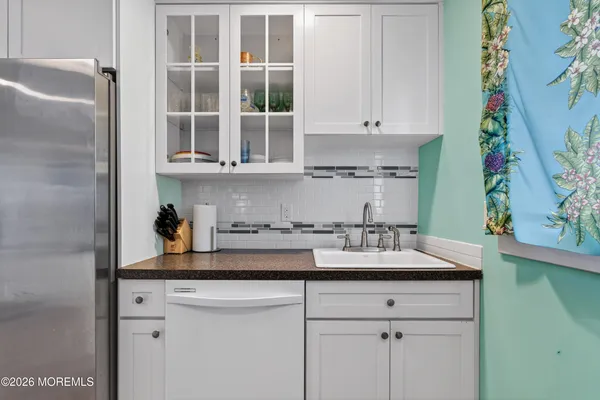 a kitchen with stainless steel appliances granite countertop a sink and a cabinets