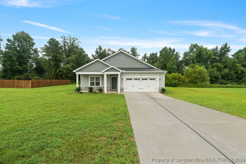 7751 Rufus Johnson Road Fayetteville, NC 28306 - Photo 1 of 21 a house with green field in front of it