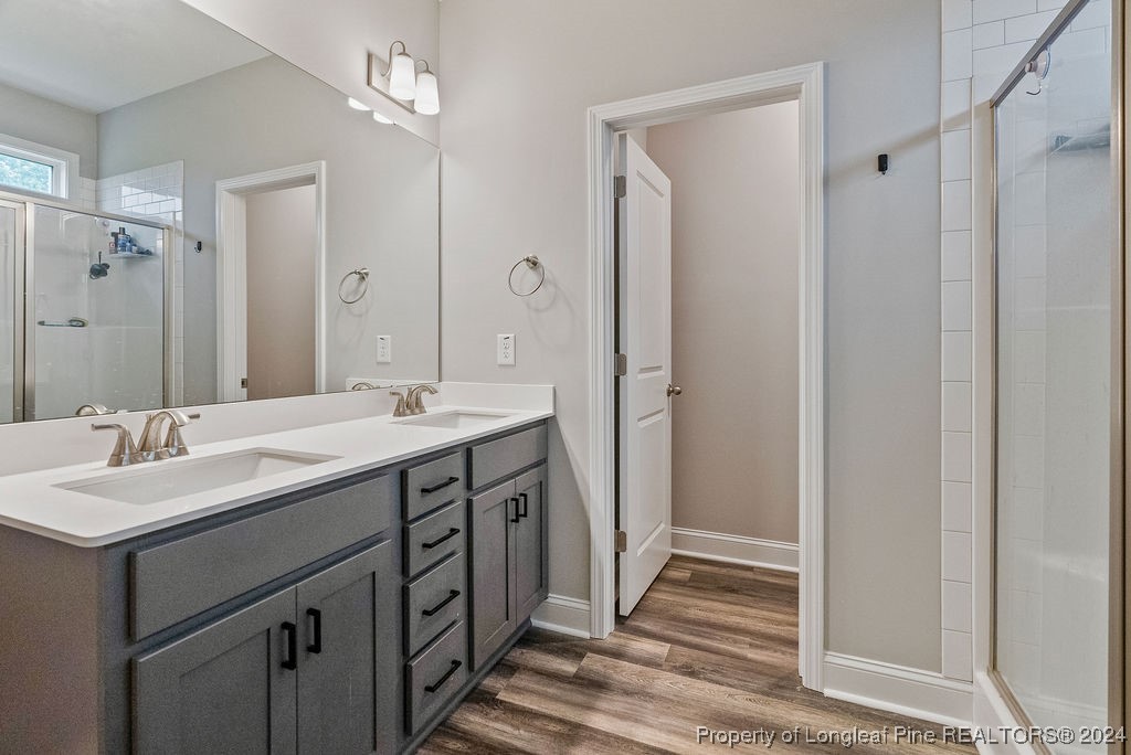 7751 Rufus Johnson Road Fayetteville, NC 28306 - Photo 11 of 21 a bathroom with a double vanity sink a and mirror