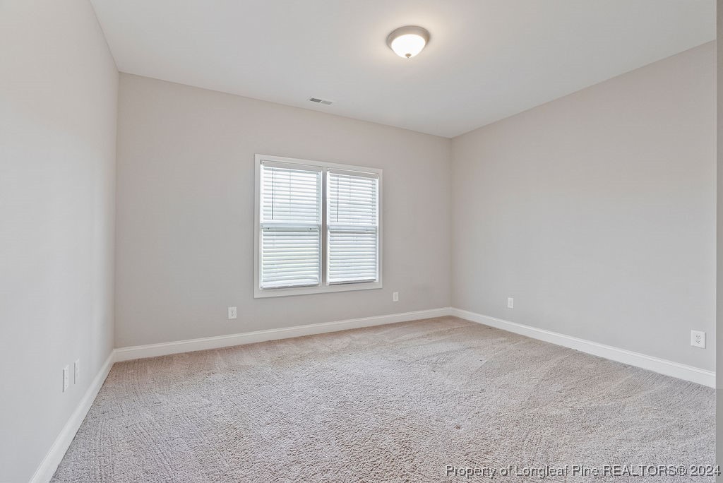 7751 Rufus Johnson Road Fayetteville, NC 28306 - Photo 13 of 21 an empty room with a window