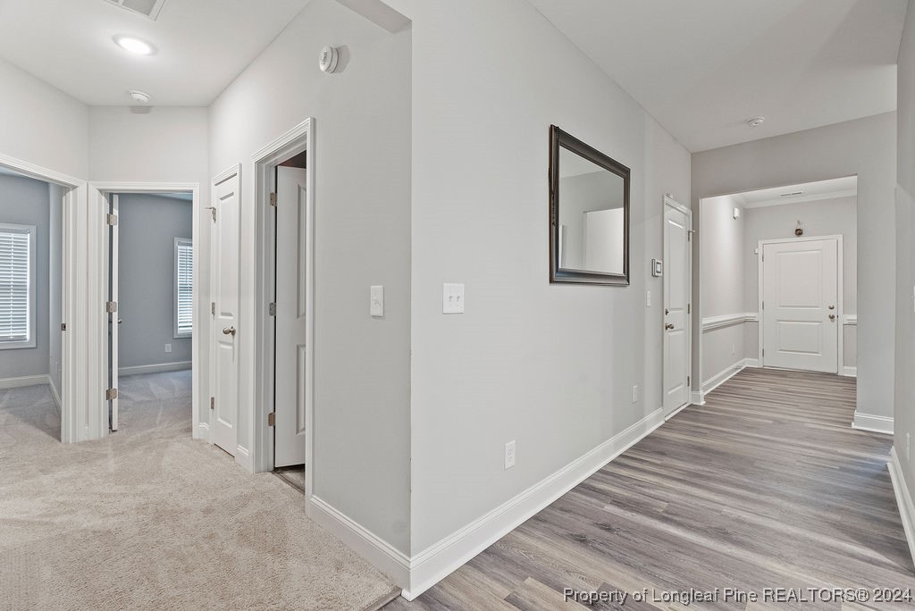 7751 Rufus Johnson Road Fayetteville, NC 28306 - Photo 15 of 21 wooden floor & windows in a hall with an entryway