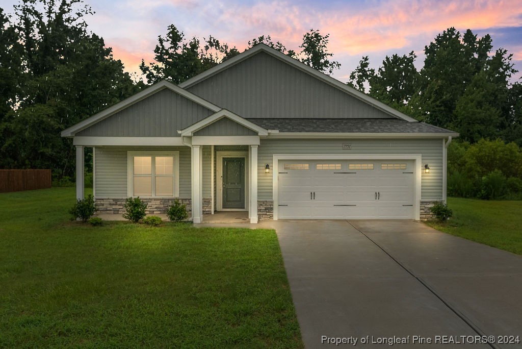 7751 Rufus Johnson Road Fayetteville, NC 28306 - Photo 2 of 21 a front view of a house with a yard and garage