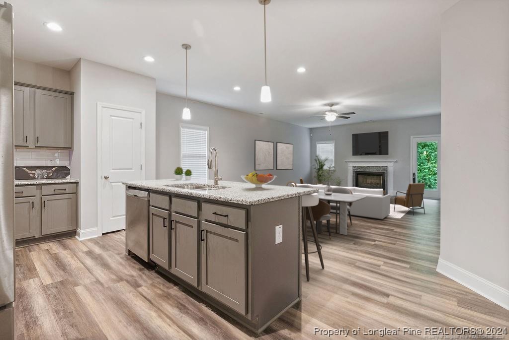 7751 Rufus Johnson Road Fayetteville, NC 28306 - Photo 6 of 21 a kitchen with kitchen island granite countertop a sink counter top space and stainless steel appliances