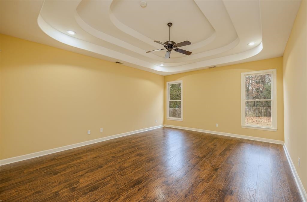 5380 Scarlet Ridge Drive Arlington, TN 38002 - Photo 15 of 35 Spacious room featuring a tiered tray ceiling with recessed lighting and a ceiling fan