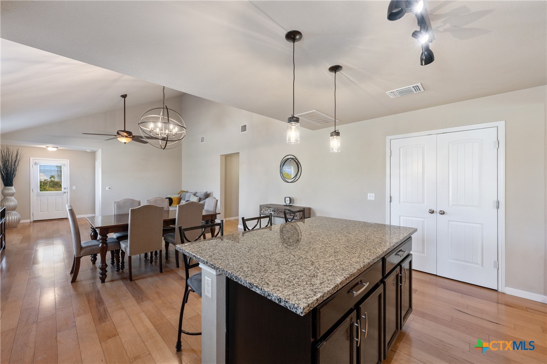 117 Liard River Road Hutto, TX 78634 - Photo 12 of 48 an open kitchen with a table and chairs in it