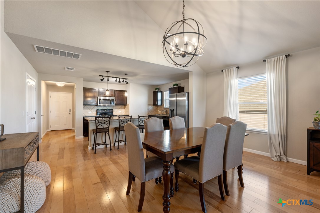 117 Liard River Road Hutto, TX 78634 - Photo 14 of 48 a view of a dining room with furniture window and wooden floor