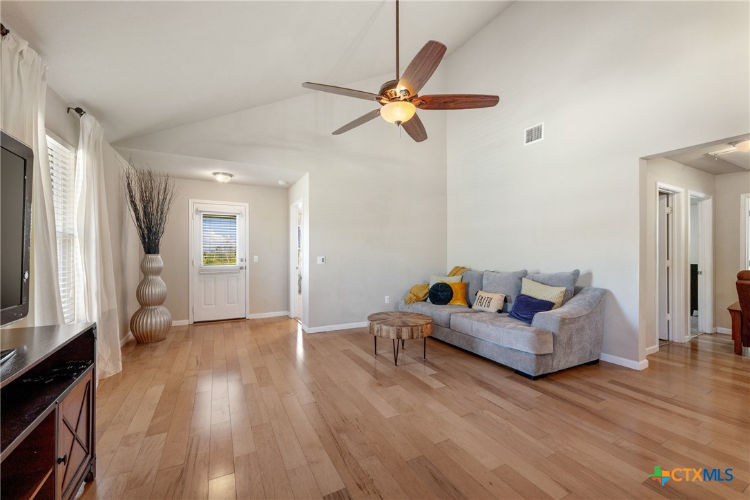 117 Liard River Road Hutto, TX 78634 - Photo 17 of 48 a living room with furniture and a wooden floor
