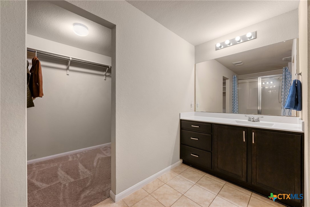 117 Liard River Road Hutto, TX 78634 - Photo 24 of 48 a bathroom with a sink vanity and a mirror