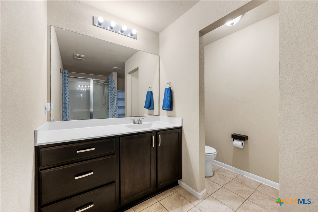 117 Liard River Road Hutto, TX 78634 - Photo 25 of 48 a bathroom with a double vanity sink and a mirror