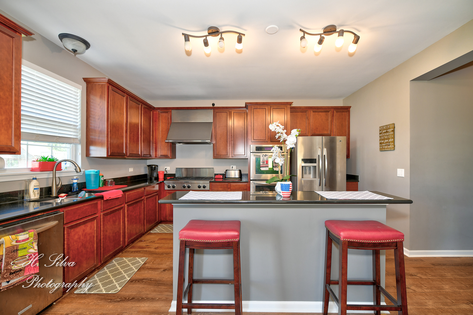249 Sonora Drive Elgin, IL 60124 - Photo 3 of 42 a kitchen with a sink a stove and chairs
