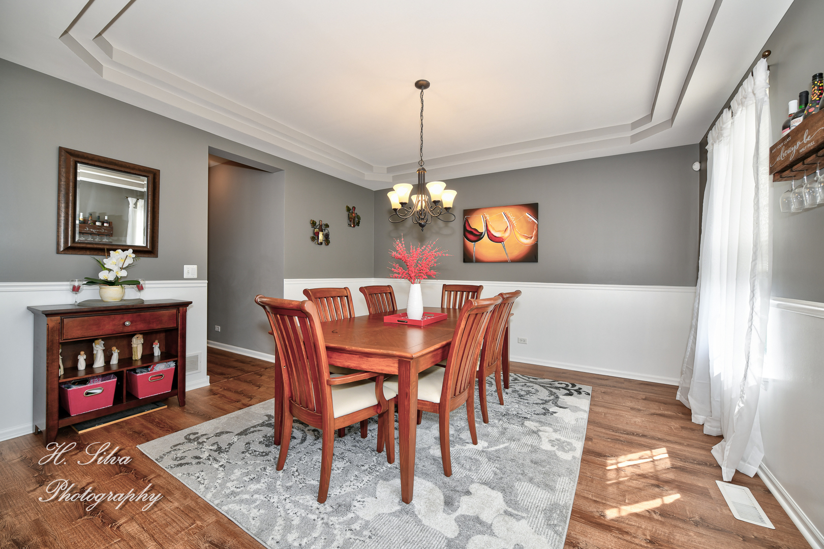 249 Sonora Drive Elgin, IL 60124 - Photo 6 of 42 a dining room with furniture a rug and a chandelier