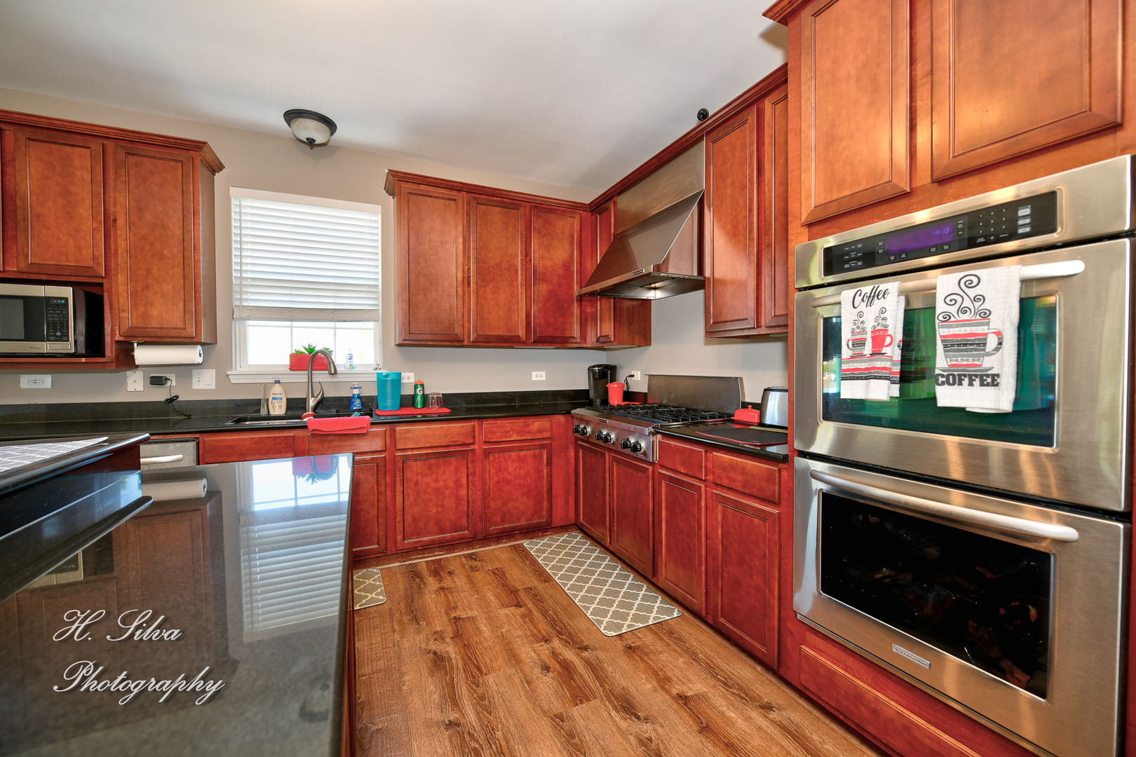 249 Sonora Drive Elgin, IL 60124 - Photo 10 of 42 a kitchen with stainless steel appliances granite countertop a stove a sink and a microwave