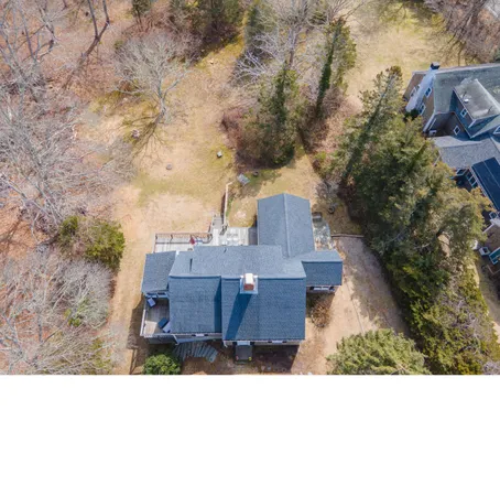 an aerial view of a house with yard basket ball court and outdoor seating