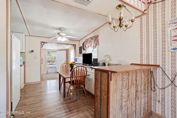 a view of a dining room with furniture and wooden floor