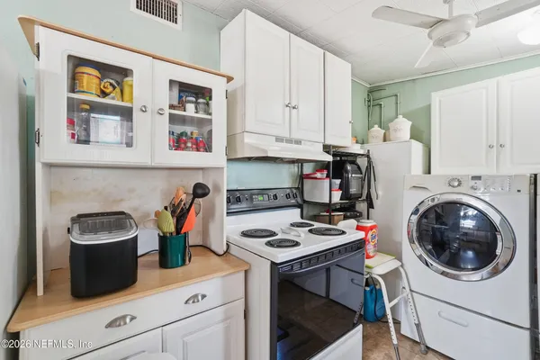 a kitchen with a sink cabinets and a stove