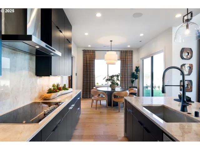 a dining room with furniture and a large window