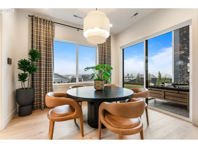 a dining room with furniture and wooden floor