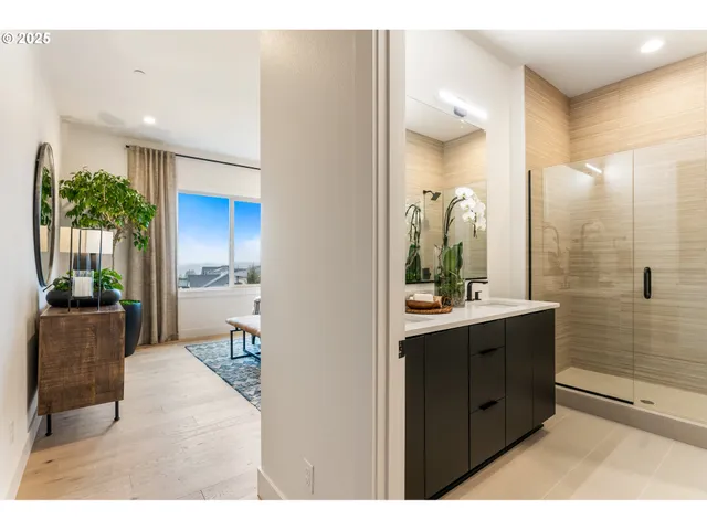 a spacious bedroom with a bed and a potted plant