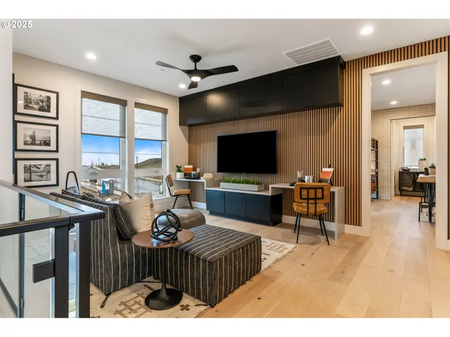 a living room with furniture and a floor to ceiling window